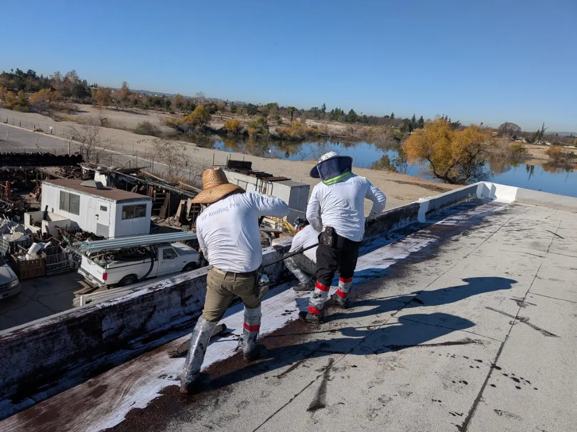 HP Roofing Pro crew performing commercial cool-roof restoration on an Inland Empire warehouse