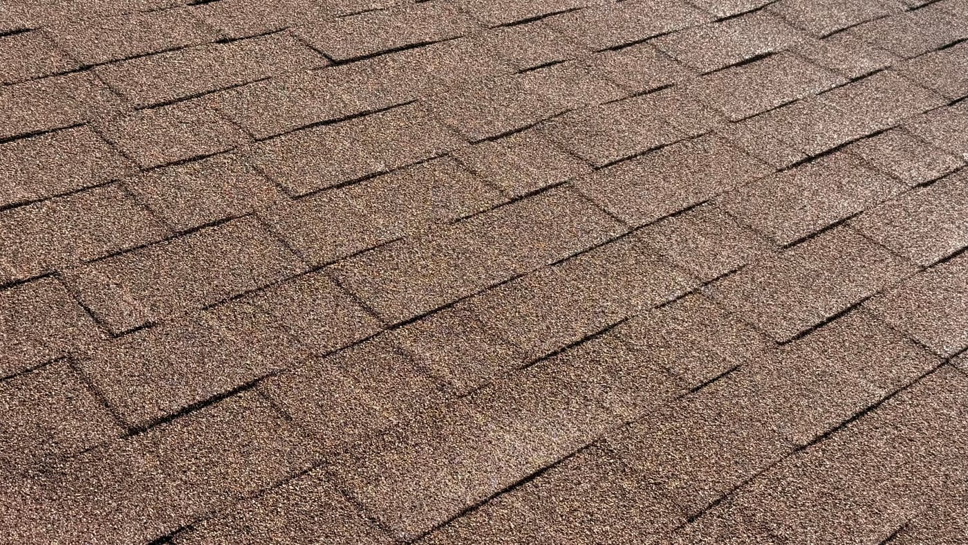 Close-up of a RainArmor-coated residential roof surface with restored granular finish