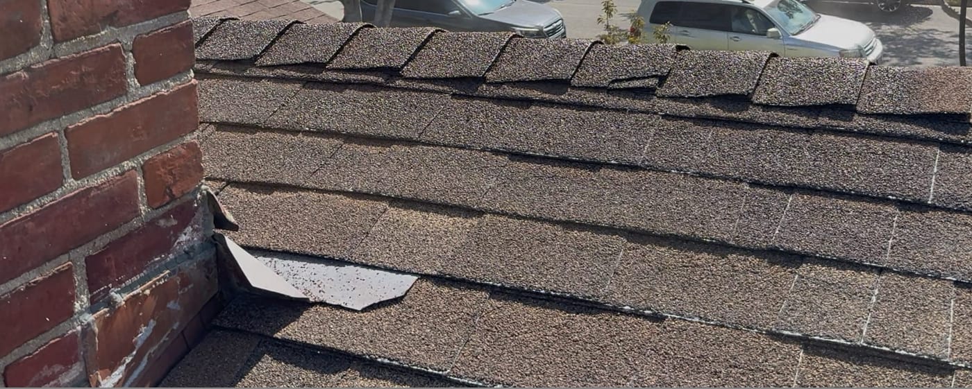 Aging asphalt shingles with surface cracking and granule loss on a San Gabriel home before RainArmor restoration