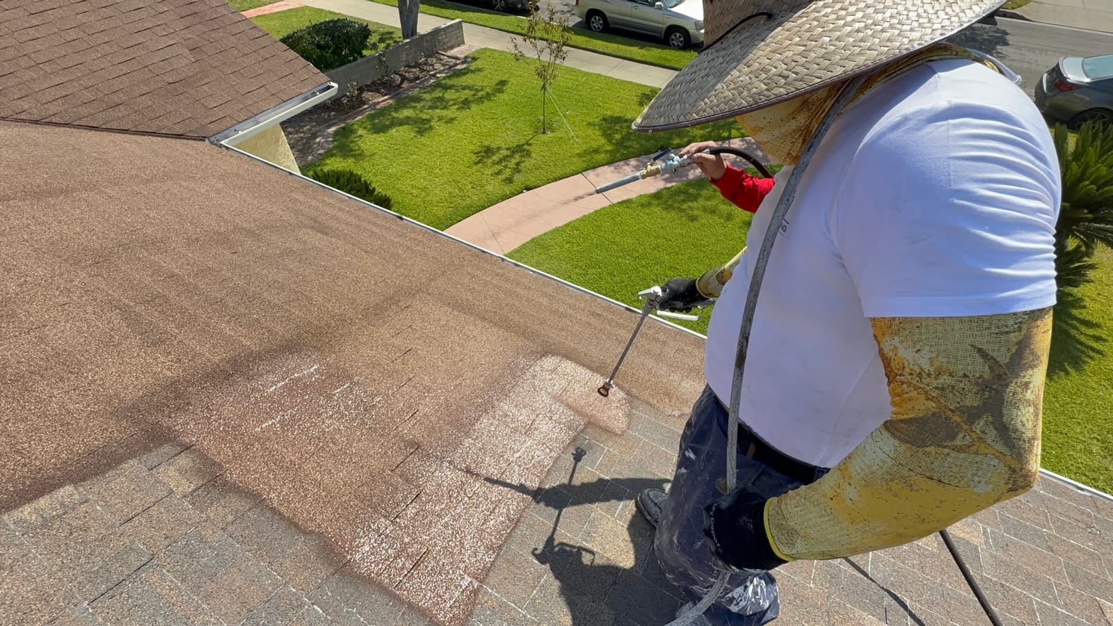HP Roofing Pro crew applying the RainArmor coating system on a roof
