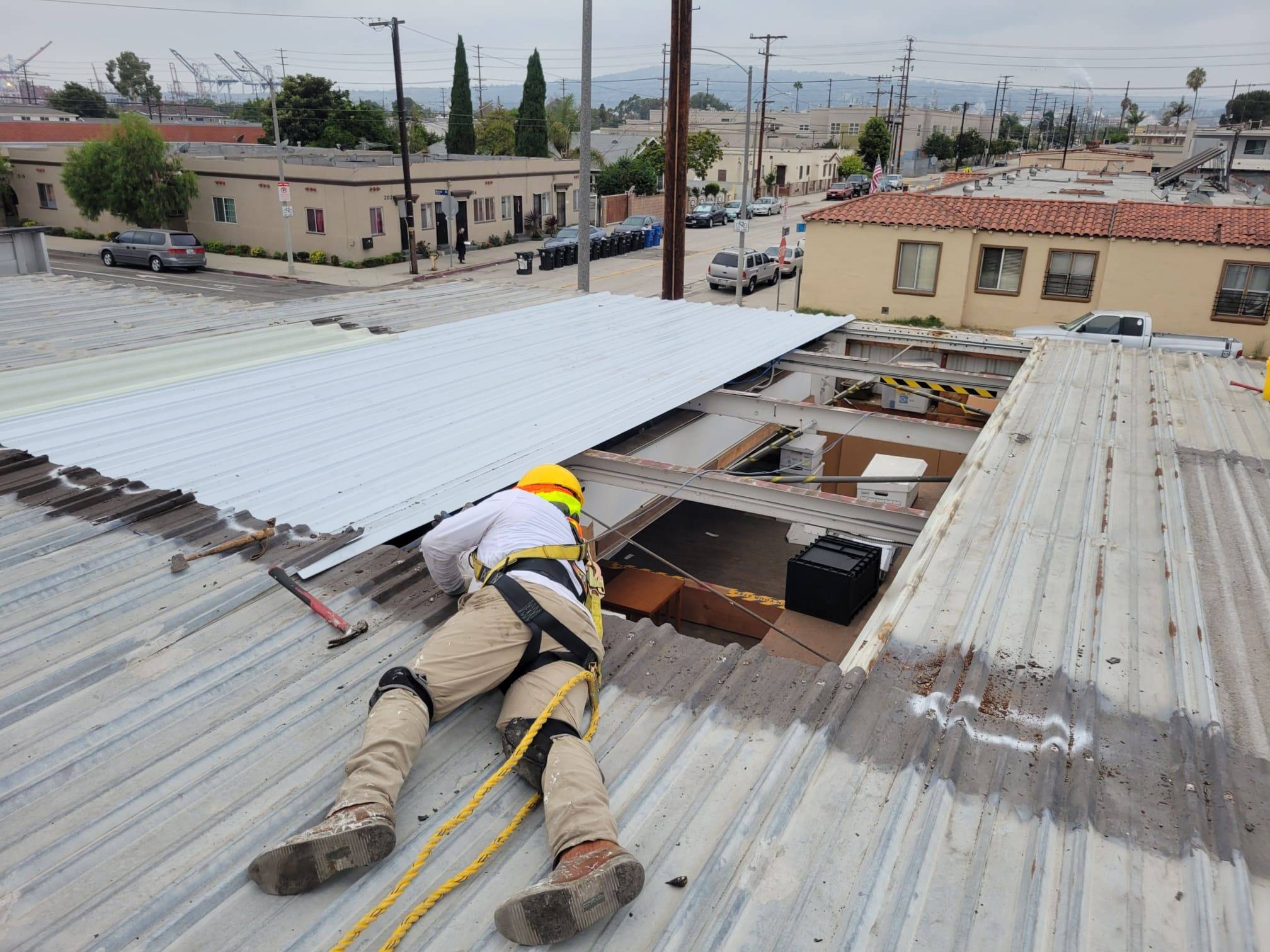 A commercial roofing contractor in Alhambra is working on the roof of a building.