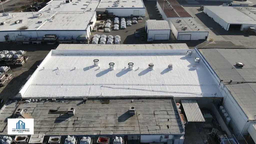 An aerial view of a warehouse with a white roof.