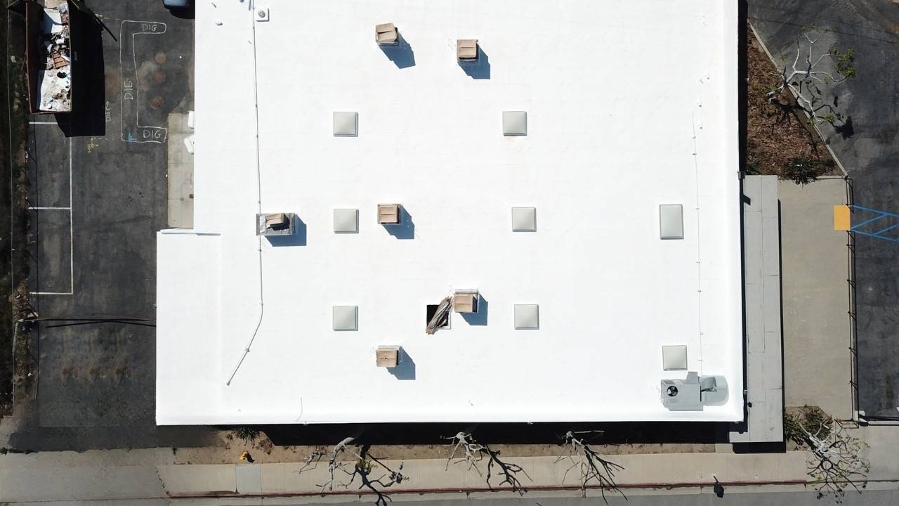 An aerial view of a white roof with boxes on it.