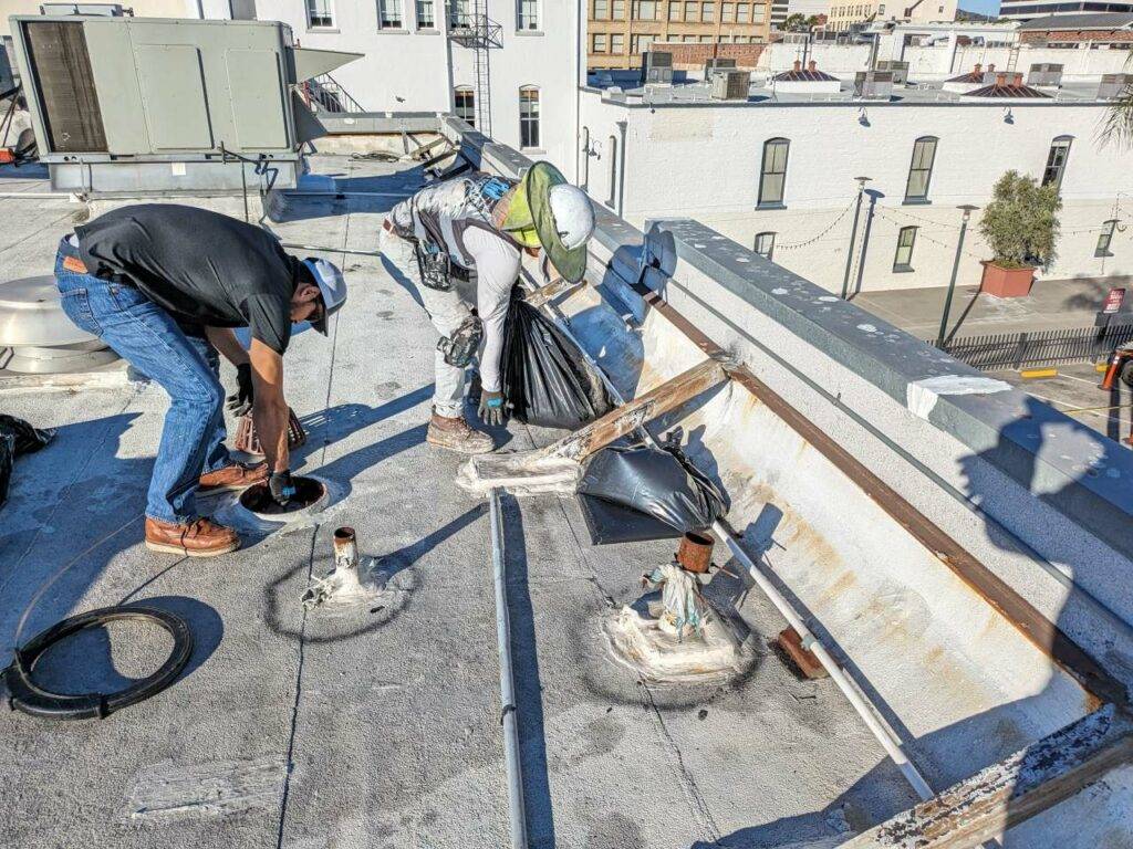 Two men working on the roof of a building.